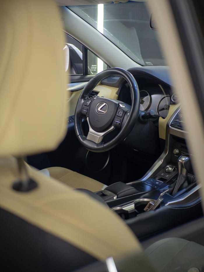 Elegant Lexus car interior showcasing luxury leather seats and steering wheel.